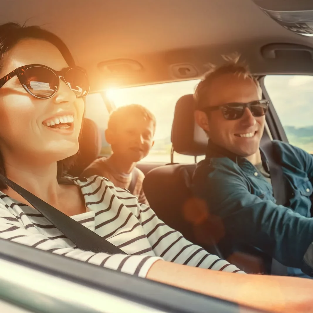 family in car smiling